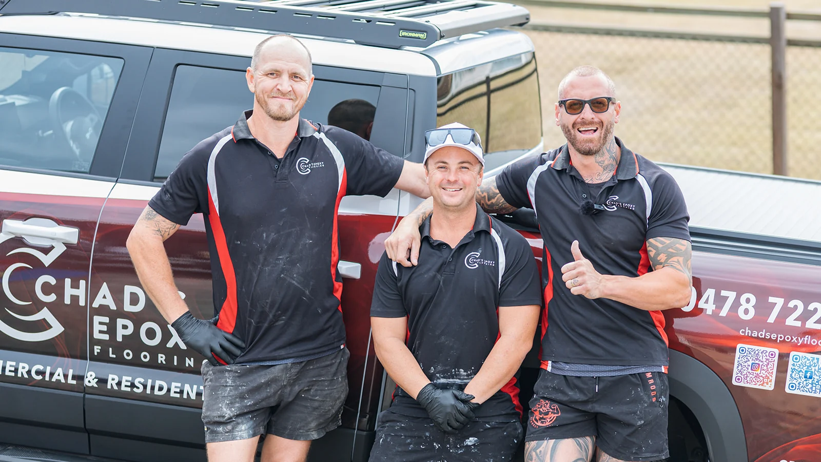 The Chad's Epoxy Flooring team smiling together beside their branded ute in Marburg
