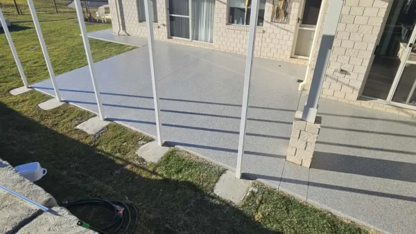 Finished coated floor on a raised outdoor verandah with white railings